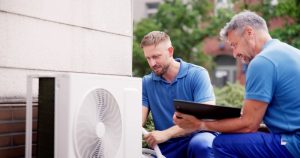 ac-unit-two-techs-installing-it